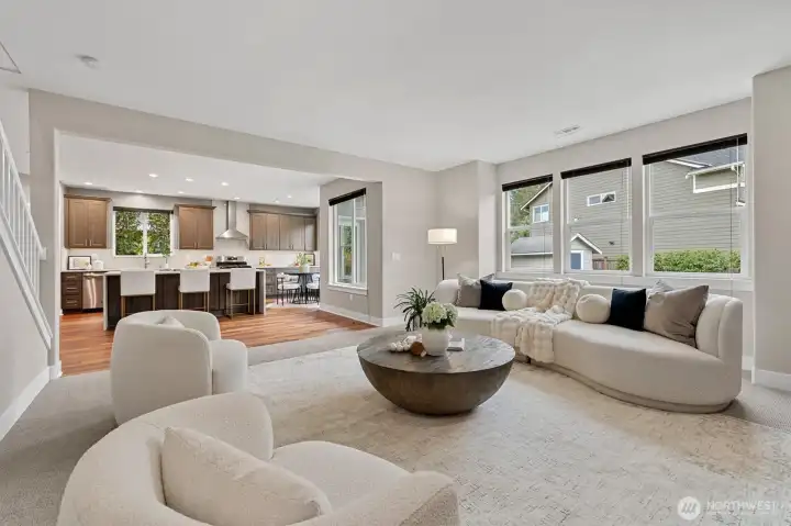 Great room with bank of windows overlooking the lush backyard!