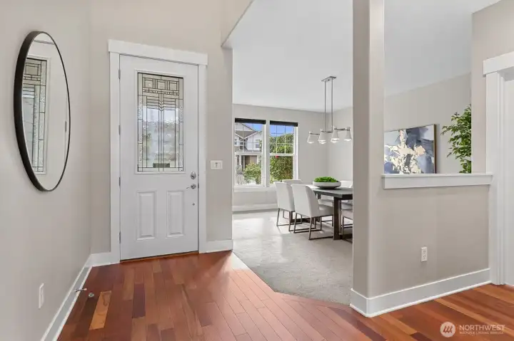 Grand entry with soaring vaulted ceilings, an oversized front door, and refinished Brazilian cherry hardwood floors, creating a bright and welcoming first impression.