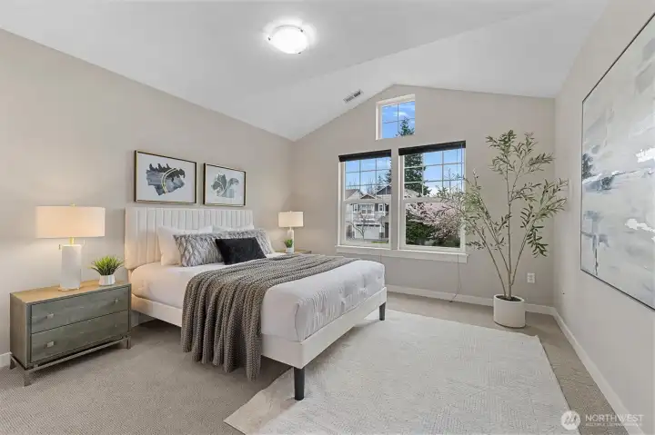 Bedroom #2:  Light-filled secondary bedroom with vaulted ceiling, offering added volume and character, ideal for guests, office, or flexible living space.