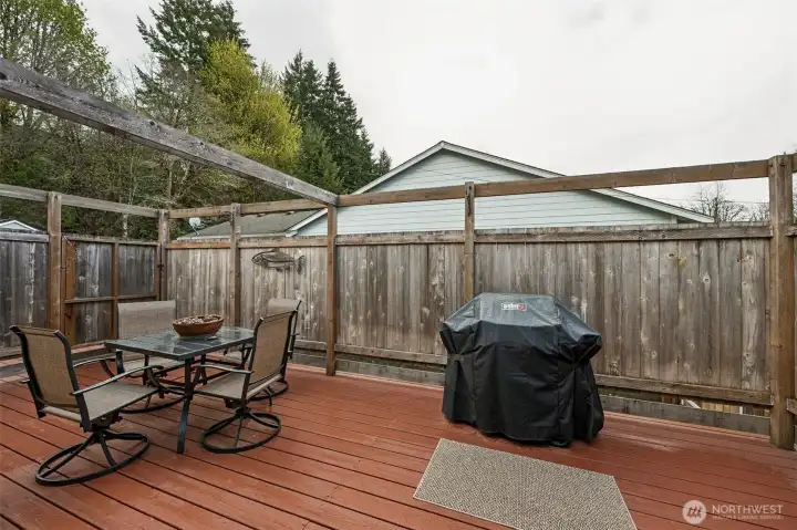 The back deck, conveniently located just off the kitchen & dining room with encompassing walls for privacy.