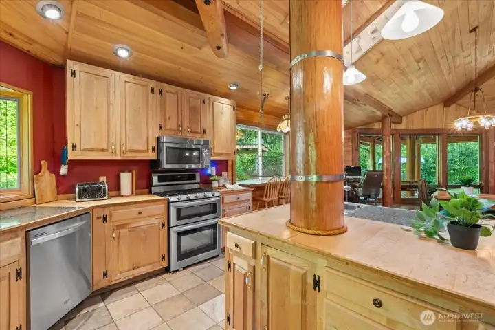 Spacious kitchen with center island, custom wood cabinetry, recessed lighting, and open sightlines to the dining and living areas. Rustic wood finishes create a cohesive lodge-style feel. Spacious kitchen with center island, custom wood cabinetry, recessed lighting, and open sightlines to the dining and living areas. Rustic wood finishes create a cohesive lodge-style feel.