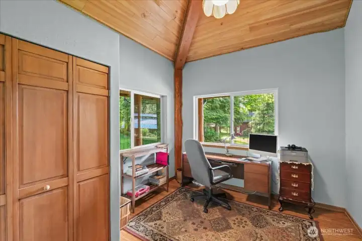 Flexible office or workspace with large windows, vaulted ceiling, and built-in closet storage. Bright setting offers a comfortable work-from-home or hobby space. Flexible office or workspace with large windows, vaulted ceiling, and built-in closet storage. Bright setting offers a comfortable work-from-home or hobby space.