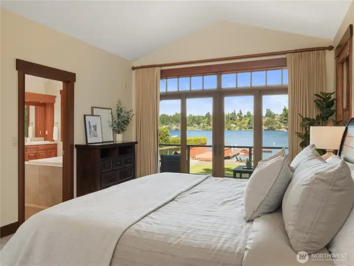 Wake up to water views from this spacious primary suite featuring large windows, vaulted ceilings, and direct access to a private balcony. Wake up to water views from this spacious primary suite featuring large windows, vaulted ceilings, and direct access to a private balcony.