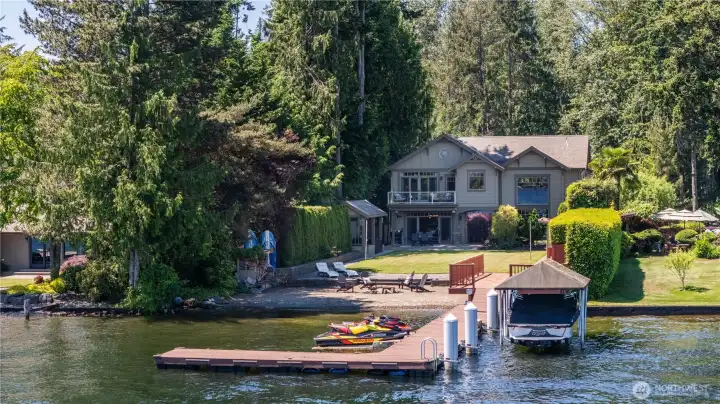 Every day features panoramic water views and spend your days enjoying the very best of lakefront living. This remarkable waterfront property features a private dock, covered boat moorage, shoreline beach area, and beautifully landscaped grounds that stretch to the water's edge. Every day features panoramic water views and spend your days enjoying the very best of lakefront living. This remarkable waterfront property features a private dock, covered boat moorage, shoreline beach area, and beautifully landscaped grounds that stretch to the water's edge.