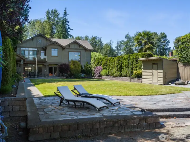 Enjoy the beauty of outdoor living with expansive lawn space, established landscaping, and a generous stone patio designed for relaxation and entertaining. Enjoy the beauty of outdoor living with expansive lawn space, established landscaping, and a generous stone patio designed for relaxation and entertaining.
