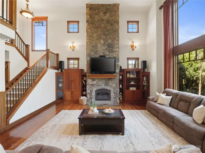 A stunning stone fireplace anchors the room, while custom built-ins, hardwood floors, and thoughtful architectural details add warmth and character. A stunning stone fireplace anchors the room, while custom built-ins, hardwood floors, and thoughtful architectural details add warmth and character.