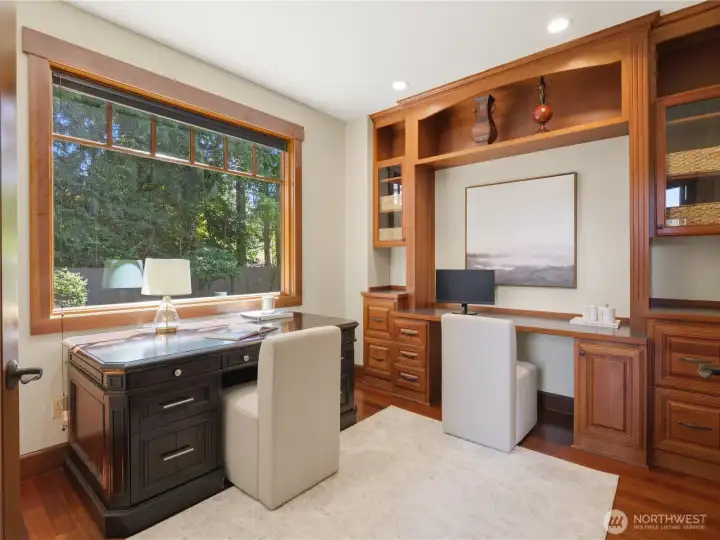 Thoughtfully crafted for productivity and comfort, the office showcases custom millwork, built-in cabinetry, and a spacious workstation framed by a large window overlooking the grounds. Thoughtfully crafted for productivity and comfort, the office showcases custom millwork, built-in cabinetry, and a spacious workstation framed by a large window overlooking the grounds.
