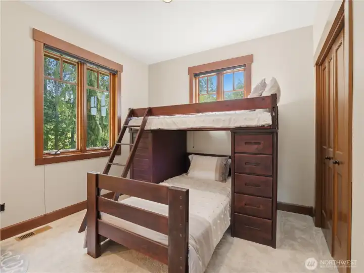 Spacious bedroom featuring extensive closet storage, large windows, and abundant natural light. Spacious bedroom featuring extensive closet storage, large windows, and abundant natural light.