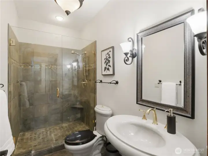 Designed with attention to detail, this bathroom features a walk-in tile shower with glass enclosure, elegant finishes, and refined fixture selections. Designed with attention to detail, this bathroom features a walk-in tile shower with glass enclosure, elegant finishes, and refined fixture selections.