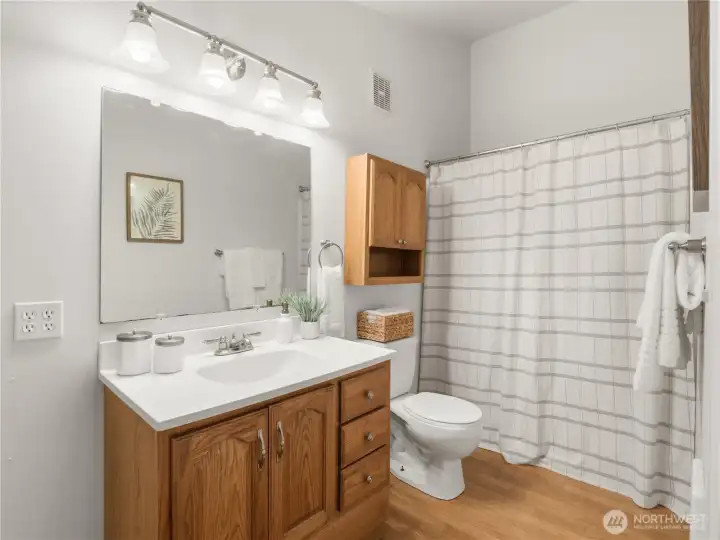 Conveniently located adjacent to the living area, this full bath offers a spacious vanity, abundant storage, and a tub/shower combination designed for practicality and comfort. Conveniently located adjacent to the living area, this full bath offers a spacious vanity, abundant storage, and a tub/shower combination designed for practicality and comfort.