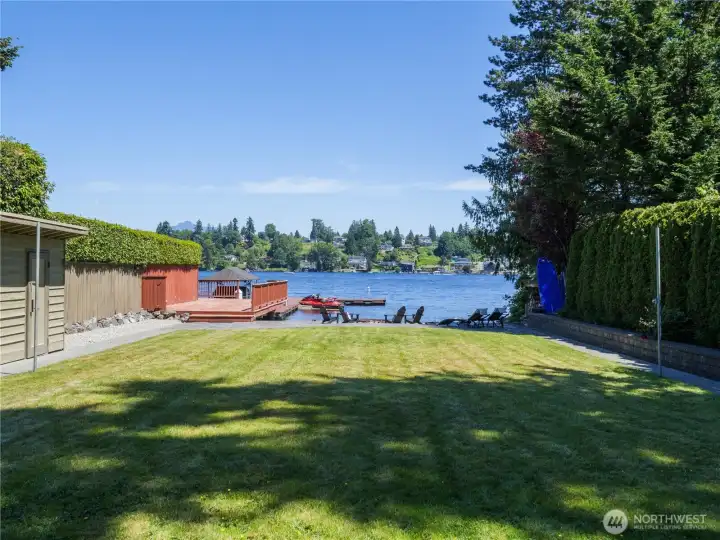 Level lawn stretches to the shoreline, creating a rare waterfront setting designed for recreation, relaxation, and entertaining. Level lawn stretches to the shoreline, creating a rare waterfront setting designed for recreation, relaxation, and entertaining.