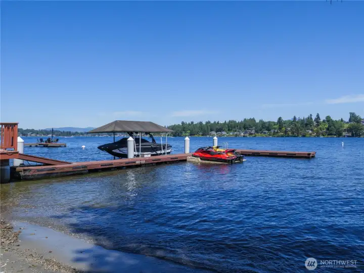Private waterfront with dock, covered boat moorage, jet ski lifts, swimming area, and panoramic lake views. Private waterfront with dock, covered boat moorage, jet ski lifts, swimming area, and panoramic lake views.