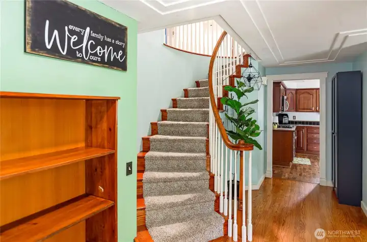 Entry showing staircase to second floor.  Main floor has hardwood and engineered floors