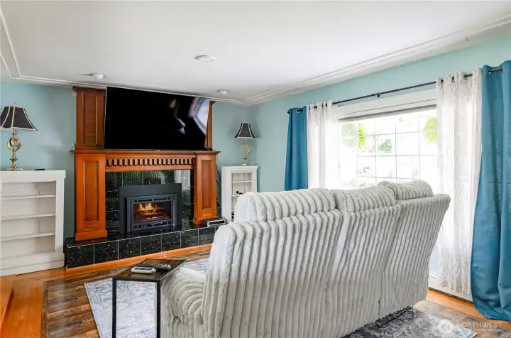 Living room has gas fireplace with custom mantel and granite tile.