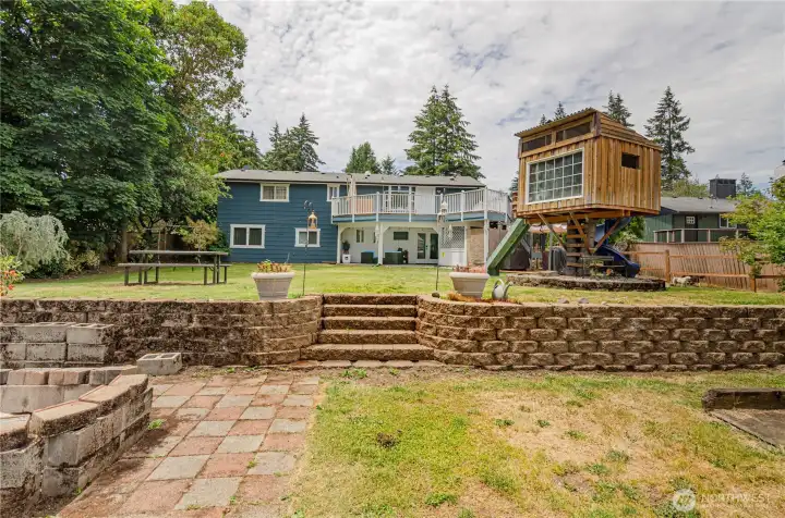 View from the back yard. Firepit and terraced lower area.