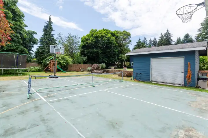Something you don't see every day, a full basketball sports court.  Shed with roll up door is perfect for storage and toys.