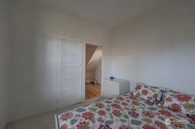 Primary bedroom with closet and looking into the hallway