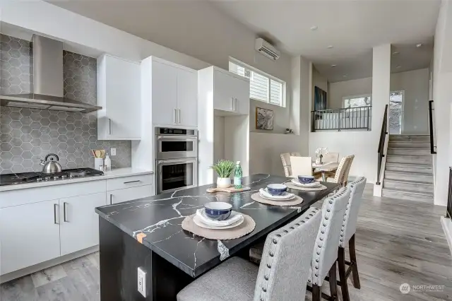 Dining and kitchen space with high ceilings! (all interior photos are from lot 24 model home - same floorplan)