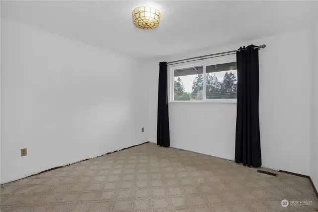 Second bedroom on upper level with view of the front yard.