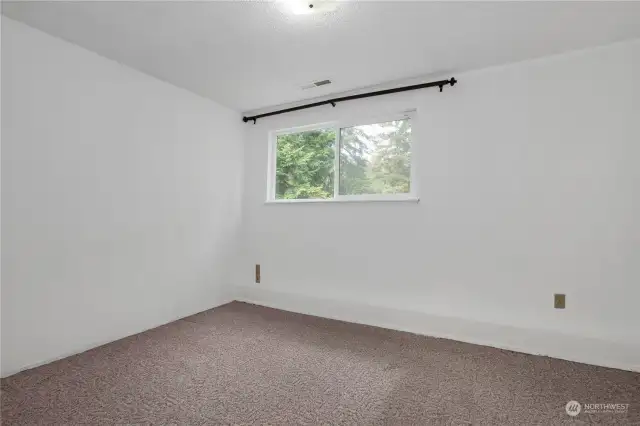 Third bedroom in the lower level with a 3/4 bathroom in hallway.