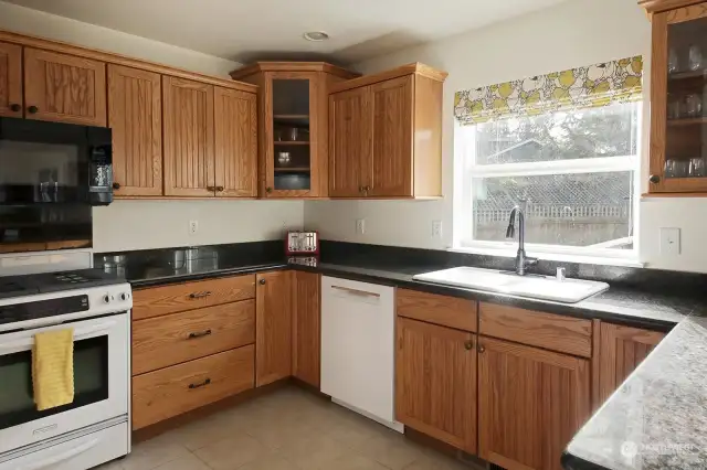 Granite countertops and ceramic tiled floors. Propane stove top/range.