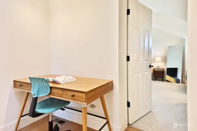Let's check out the Primary Suite first. Bamboo floors continue up the stairs and onto this flex space. Both upper level bedrooms have wall to wall carpet.