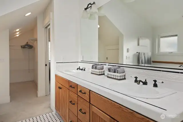 We are in the Primary Bathroom looking back towards the bedroom (shower is to your back). Note walk in closet straight ahead. There is an additional storage area to the left of the walk in closet (door to this storage area can be seen in the mirror reflection in this photo).