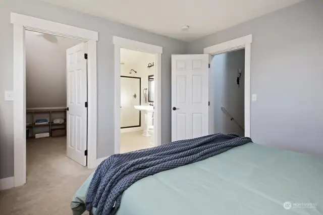 Walk in Closet to your left and 3/4 bath to the right with glimpse of the stairwell through the door on your far right. Note the custom trim work in this home. You will experience the quality of this home throughout your tour.