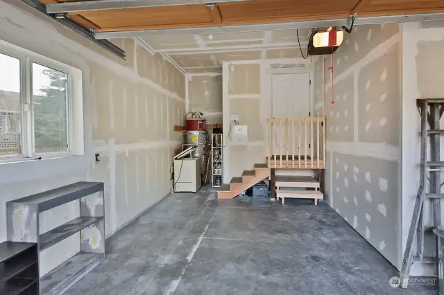 Here is a view of your garage. There is an electric car charger here and more open storage space to the right edge of this photo.
