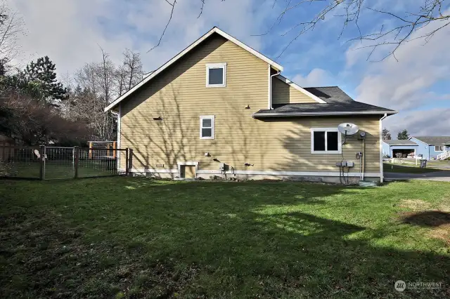 This is the side of your home that would welcome that upper level view deck. There is also space here to expand your fenced yard area if desired.
