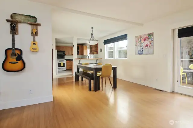 The propane fireplace is to your back and you can now see into the kitchen & dining area. There is a closet located along the wall to the left of the dining room table. A great coat closet!