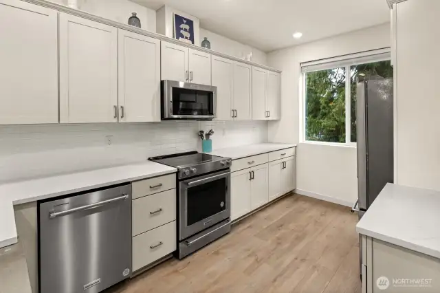 Open concept living/dining/kitchen- high ceilings, AC & tons of natural light