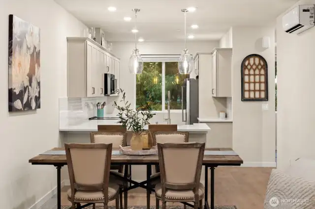 Open concept living/dining/kitchen- high ceilings, AC & tons of natural light