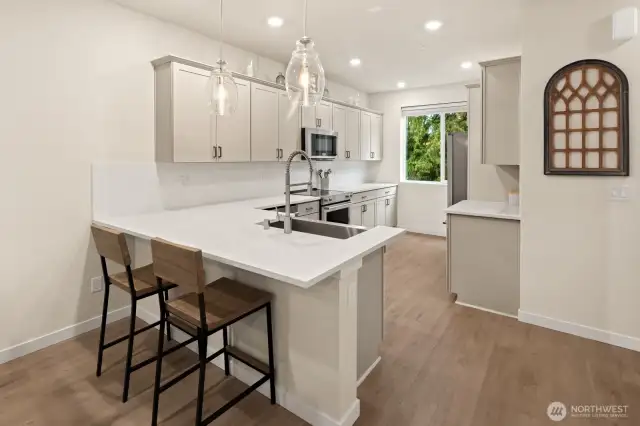 Open concept living/dining/kitchen- high ceilings, AC & tons of natural light
