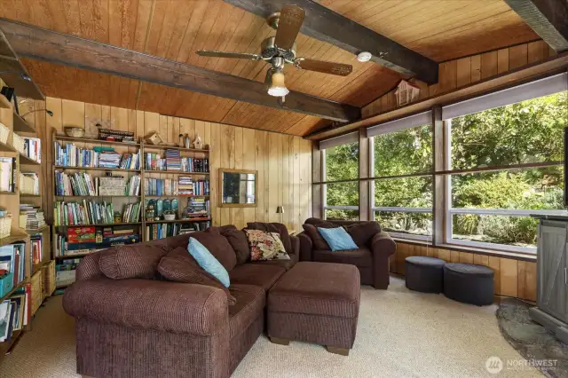 Old world style family room at the back of the house has rock fireplace