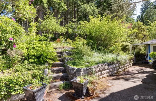 Steps from the patio lead up the hill to the tucked away firepit