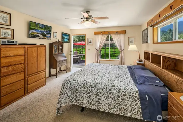 Roomy primary bedroom with your own private door to back patio and panoramic views of the mountains and fields