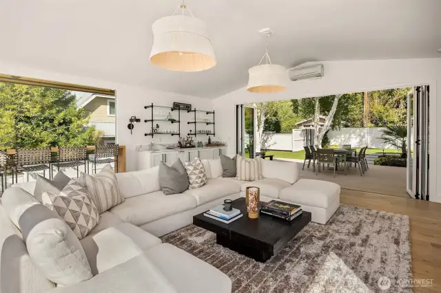 An incredible space... the entire western wall of glass opens to a huge composite deck and fully fenced front yard.