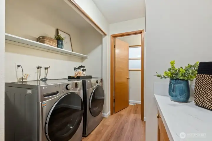 New quartz surfaces in the bathrooms and laundry room add a touch of luxury