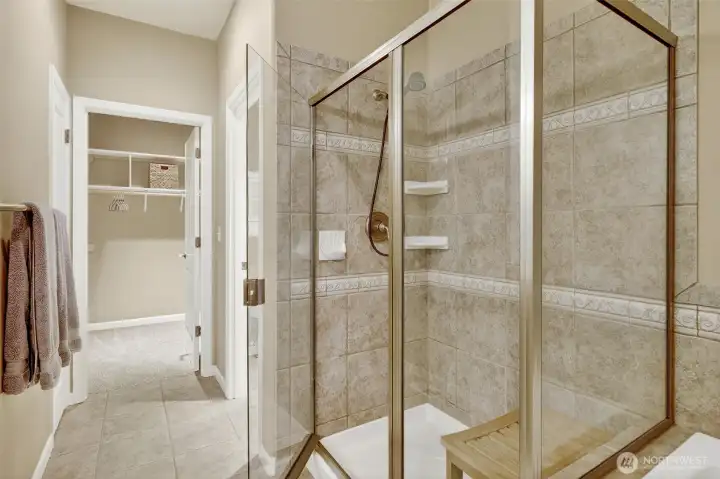 walk-in shower with brushed nickel finishes