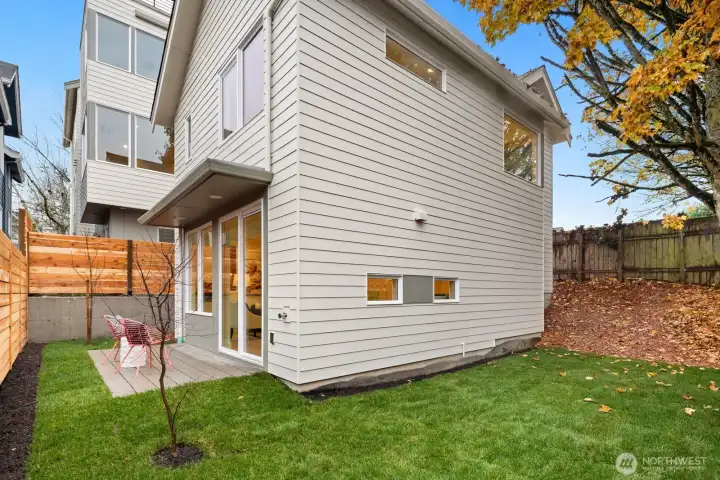 Sideyard wraps around to the backyard area.