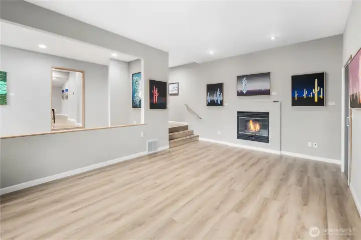 Spacious main-level living area with spectacular new floors, recessed lighting, cozy gas fireplace, display niches, and versatile layout for entertaining. Adjoining open formal dining space means everyone can be together.