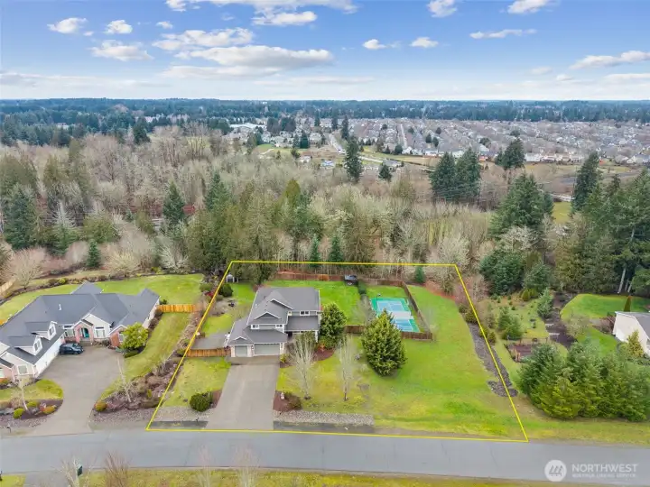 So many options await you on this expansive lot. RV parking on the left through the double gate and sports court to the right.  Plus 5 bedrooms, a media room and bonus room.  Options are endless.