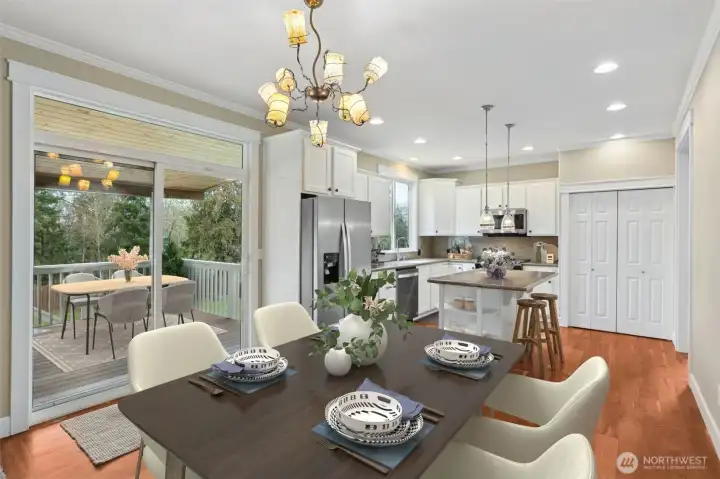 This casual dining area keeps things light and inviting with a whimsical but elegant light fixture setting the tone overhead, and large sliding glass door with an upper accent window bringing in tons of natural light. You’ve got easy access back into the kitchen, with the two door pantry closet right there when you need it.