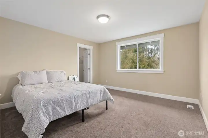 Bedroom #2 upstairs is bigger than expected and nicely balanced. The backyard facing window brings in light and a peaceful view, the carpeting keeps things cozy, and the muslin toned walls make it easy to layer in any style. The walk in closet is a real bonus, especially for a secondary bedroom, giving you storage without sacrificing floor space.