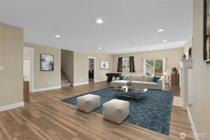 Big, bright, and fully finished, this downstairs daylight recreation room features medium tone wood floors that warm the space right up, soft muslin walls, and a crisp white ceiling that keeps everything feeling light. The gas fireplace with a classic white mantle adds a cozy focal point without stealing the show, and the large window and sliding glass door brings in plenty of natural light. Media room, recreation space, or home pub gathering zone, this room is ready to flex!