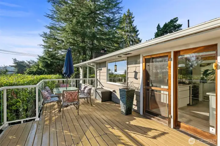 Updated deck with modern aluminum-and-glass railing overlooking Lake Washington—perfect for entertaining, relaxing, and enjoying sunrise views toward Mount Rainier.