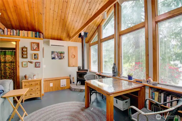 Living area gives cabin vibes with woodstove and space to gather.