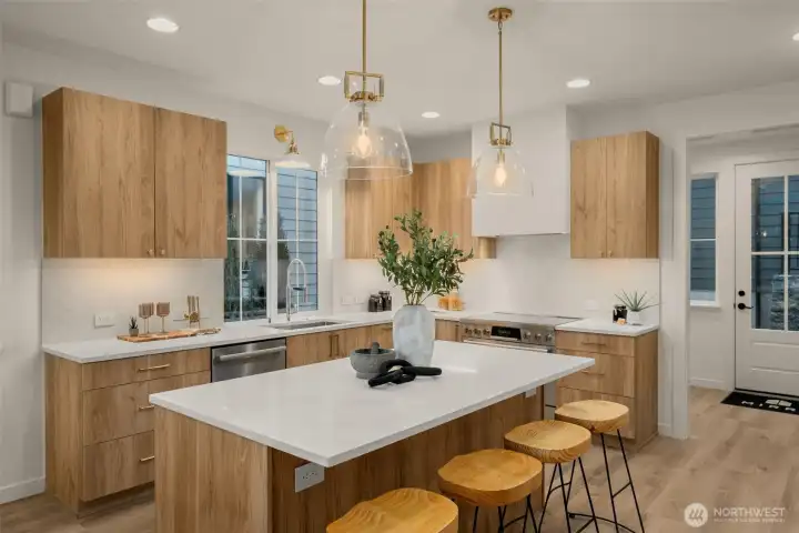 A kitchen designed to gather — generous island, custom cabinetry, and quartz counters.