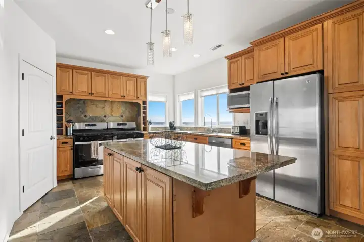 Large cooks kitchen with huge walk-in pantry that includes a second refrigerator and lots of shelves.